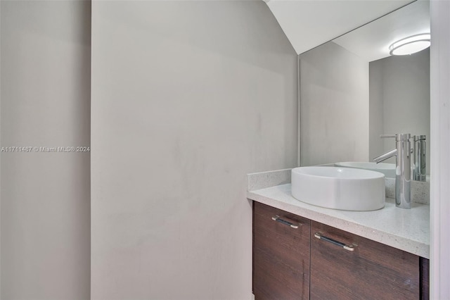 bathroom featuring vanity and vaulted ceiling