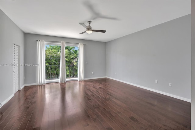 empty room with ceiling fan and dark hardwood / wood-style flooring