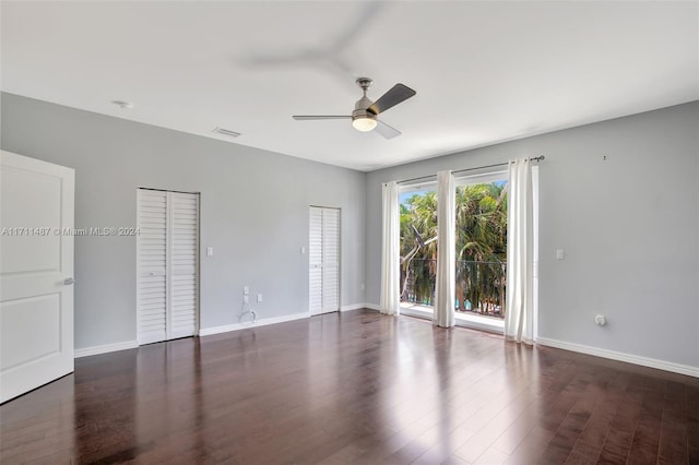 spare room featuring dark hardwood / wood-style floors and ceiling fan