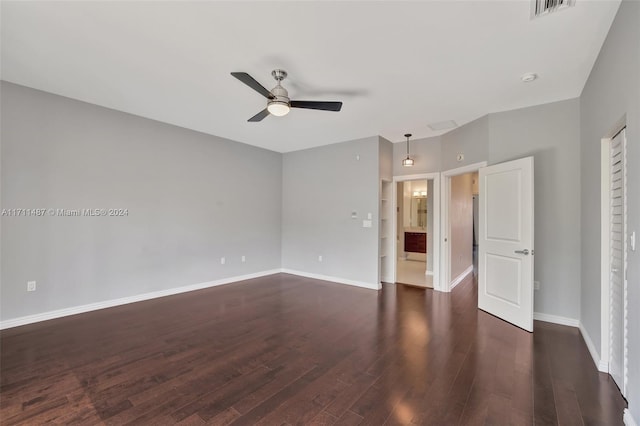 spare room with ceiling fan and dark hardwood / wood-style floors