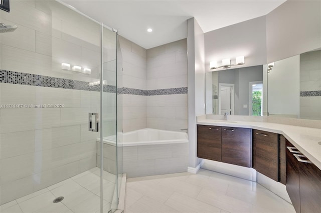 bathroom with tile patterned flooring, vanity, and independent shower and bath