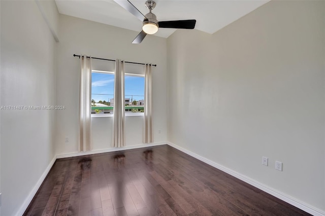 unfurnished room featuring dark hardwood / wood-style floors, ceiling fan, and vaulted ceiling