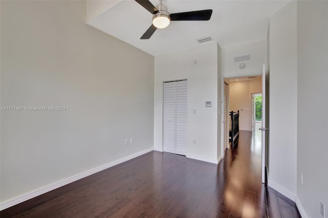 spare room with ceiling fan and dark wood-type flooring