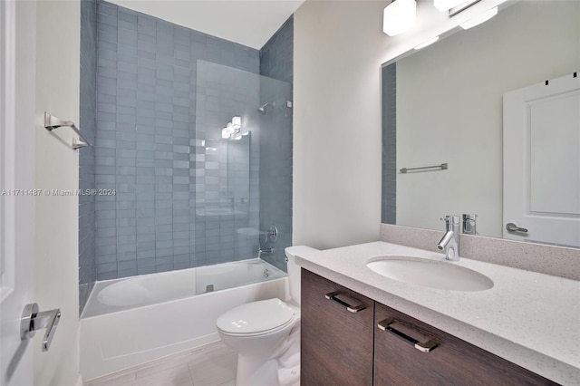 full bathroom with tile patterned flooring, vanity, toilet, and tiled shower / bath