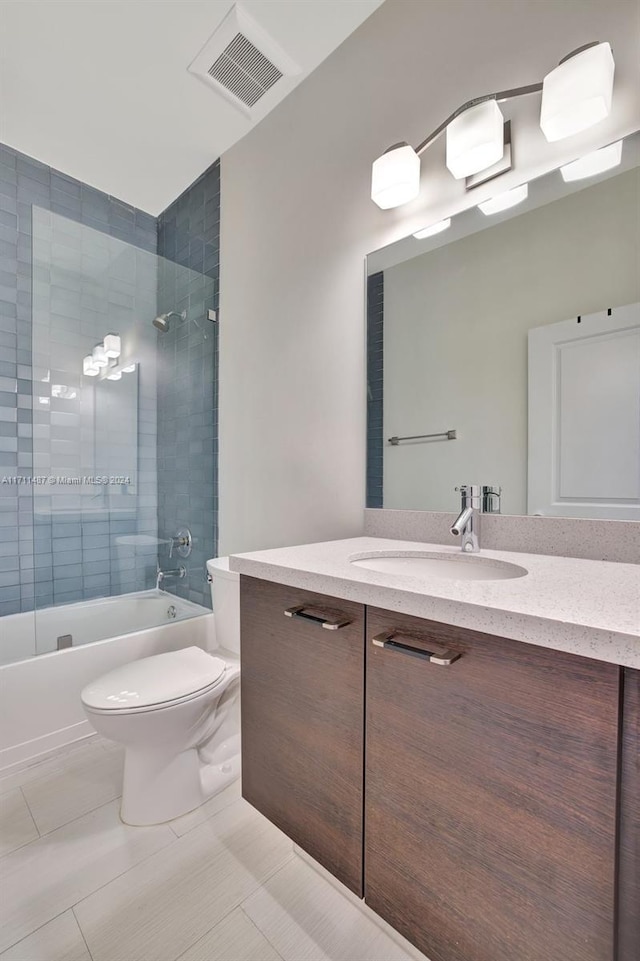 full bathroom with tile patterned floors, vanity, toilet, and tiled shower / bath