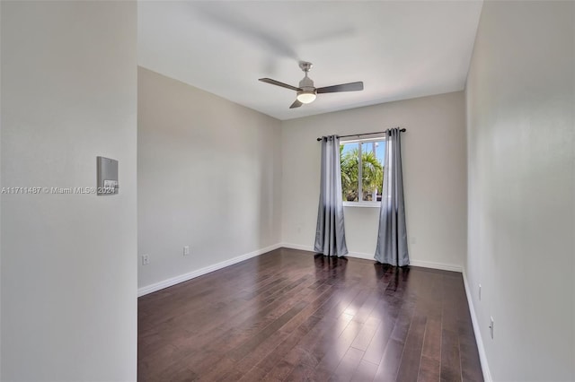 empty room with dark hardwood / wood-style floors and ceiling fan