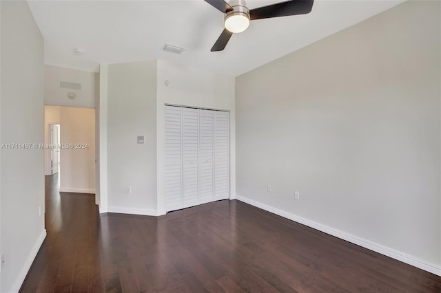 unfurnished bedroom with a closet, ceiling fan, and dark wood-type flooring