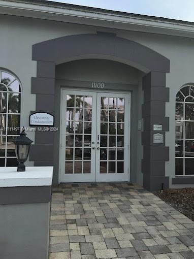 property entrance featuring french doors