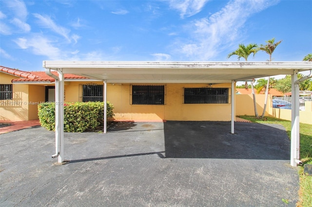 view of car parking with a carport and fence