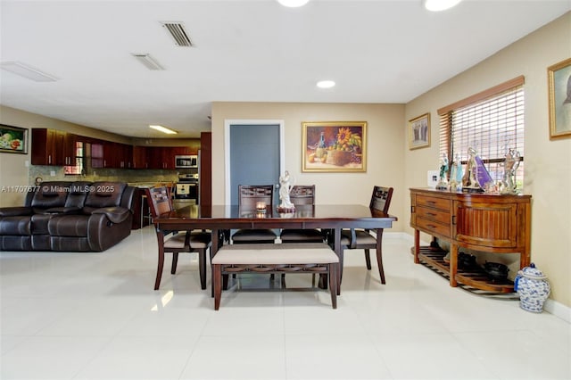 dining area featuring a wealth of natural light, visible vents, and baseboards