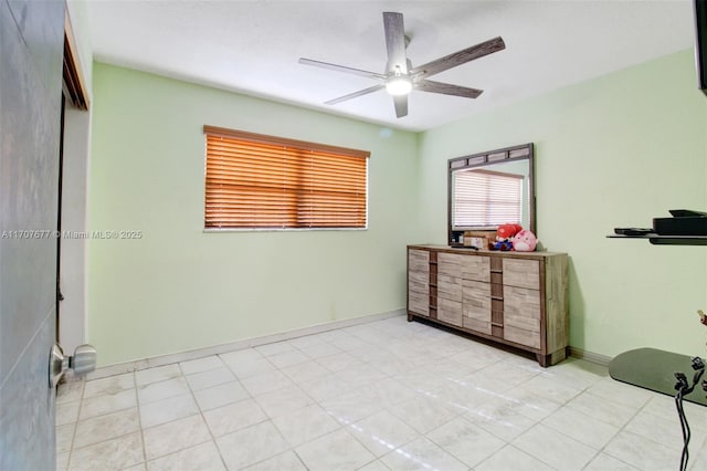 bedroom featuring ceiling fan and baseboards