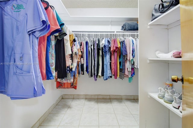 spacious closet featuring tile patterned floors