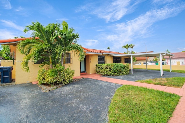 view of front of house featuring a tile roof and stucco siding