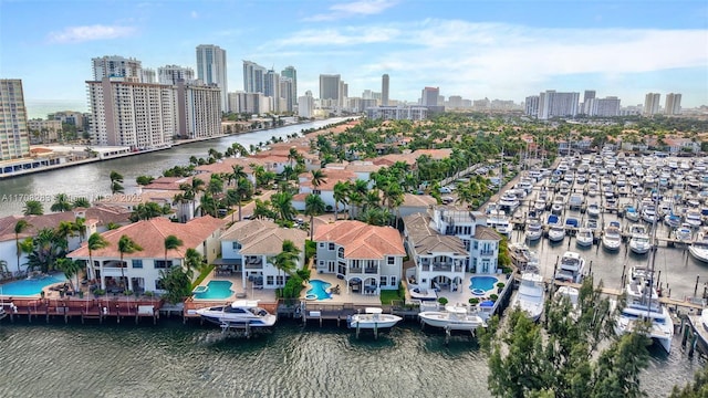 drone / aerial view featuring a view of city and a water view