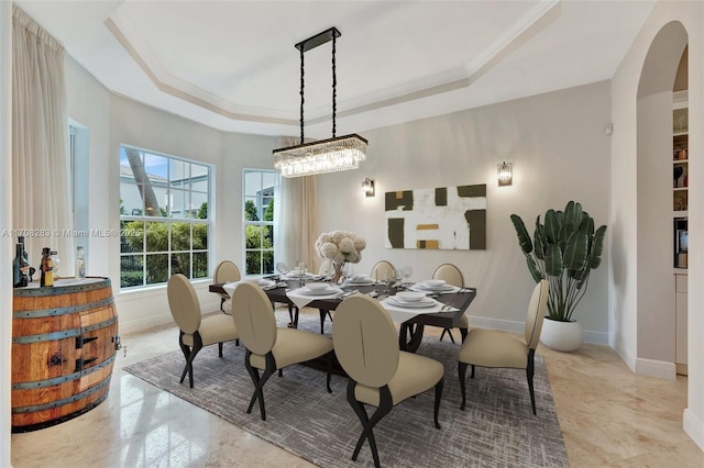 dining space featuring crown molding and a tray ceiling