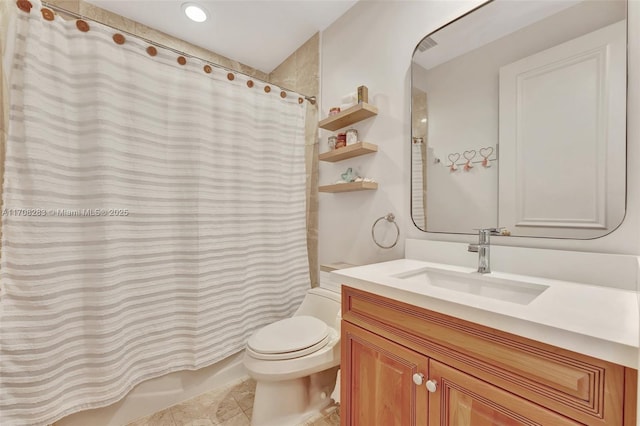 bathroom featuring tile patterned flooring, vanity, toilet, and shower / bath combo with shower curtain