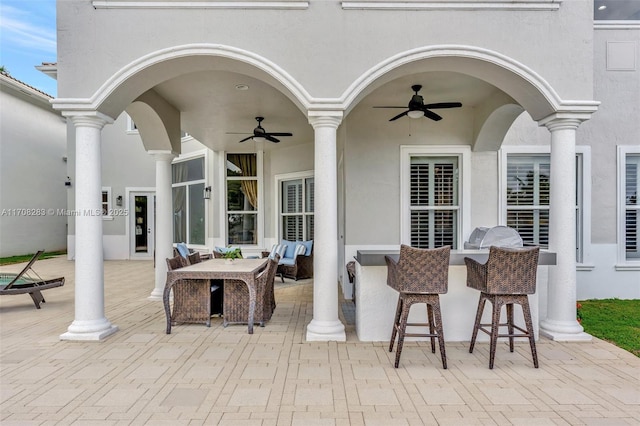 view of patio / terrace featuring outdoor dry bar, an outdoor hangout area, and a ceiling fan