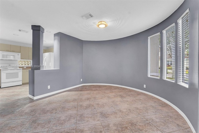 spare room featuring light tile patterned floors