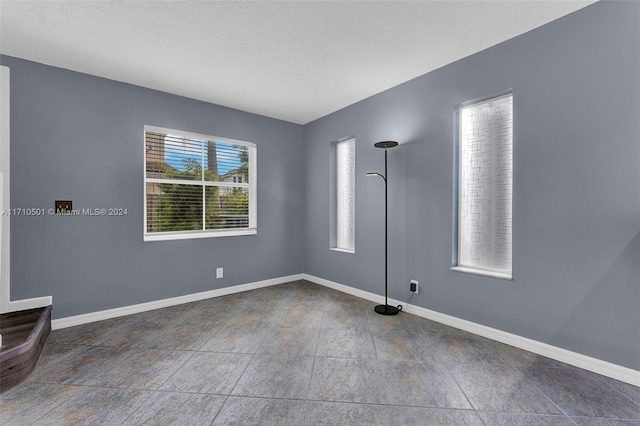 empty room with a textured ceiling