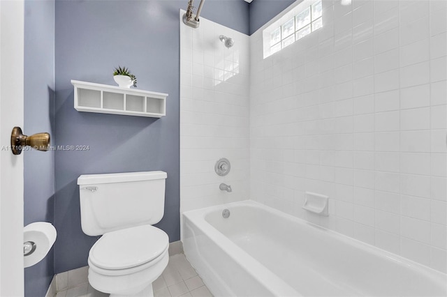 bathroom with tile patterned floors, tiled shower / bath combo, and toilet