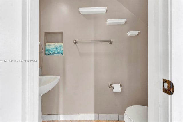 bathroom featuring tile patterned flooring and toilet