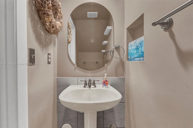 bathroom with tile walls and sink