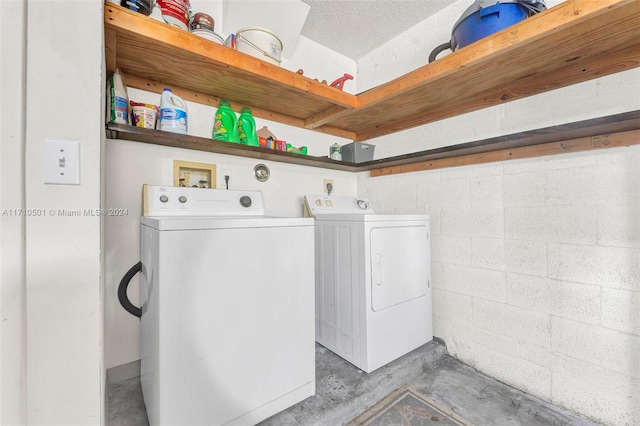 laundry area featuring washer and dryer and a textured ceiling