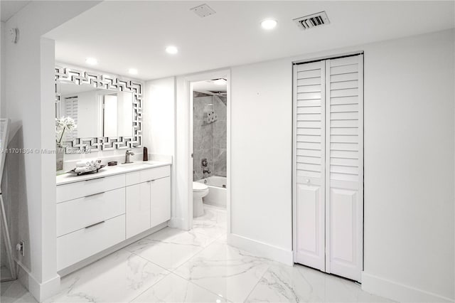 full bathroom with vanity, toilet, and tiled shower / bath