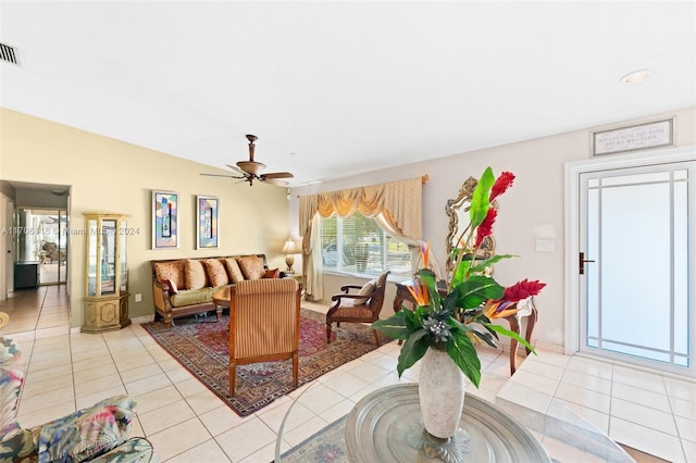 living room featuring light tile patterned floors and ceiling fan