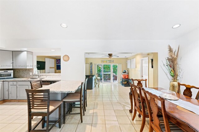 tiled dining space featuring sink