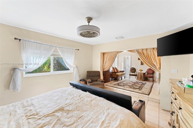 bedroom featuring light tile patterned flooring