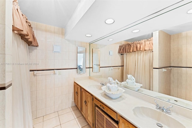 bathroom featuring tile patterned flooring, vanity, and tile walls