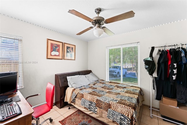 bedroom with ceiling fan and light tile patterned floors