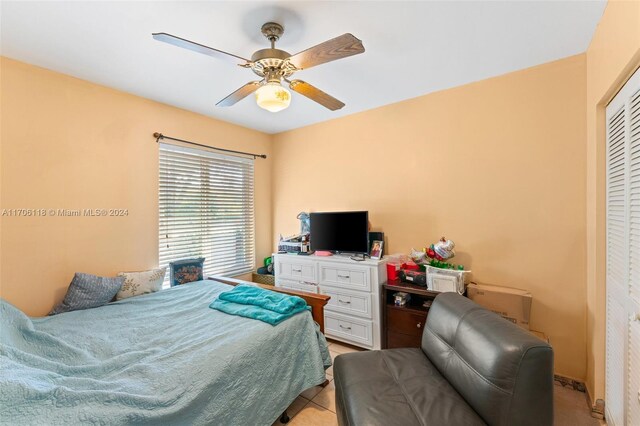 tiled bedroom with a closet and ceiling fan