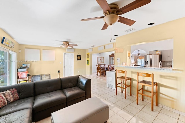 living room featuring ceiling fan and light tile patterned floors