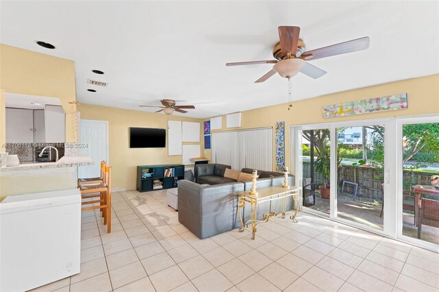 tiled living room featuring ceiling fan