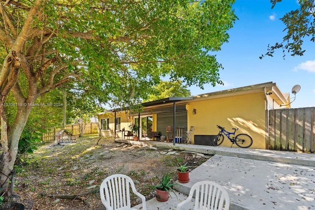 back of house with a patio