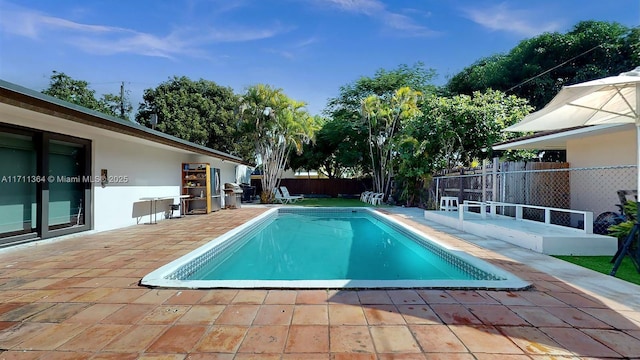 16313 SW 99th Pl, Miami, FL 33157 - view of swimming pool featuring a fenced in pool, a patio, and fence