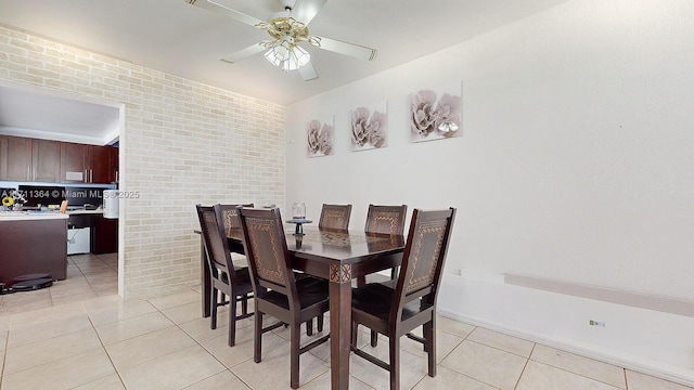 tiled dining area with brick wall and ceiling fan