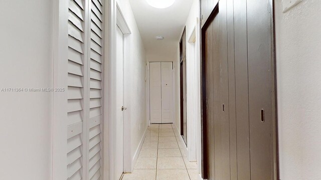 hall featuring light tile patterned floors