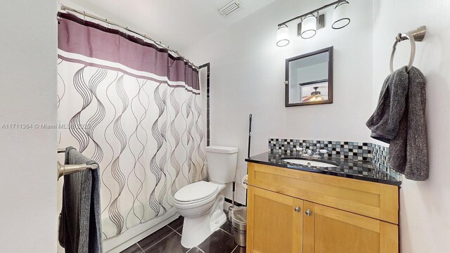 bathroom with toilet, vanity, tile patterned flooring, and curtained shower