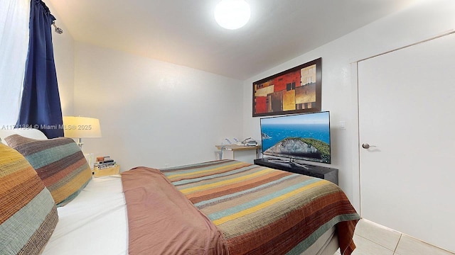 bedroom with light tile patterned floors