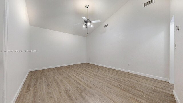 spare room with ceiling fan, high vaulted ceiling, and light hardwood / wood-style flooring