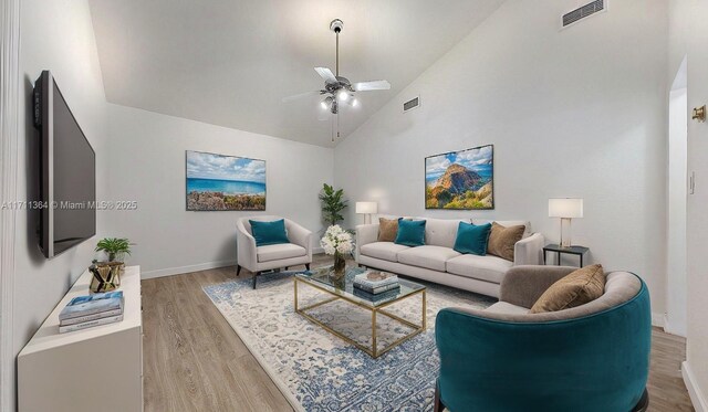 living room with ceiling fan, light hardwood / wood-style floors, and high vaulted ceiling