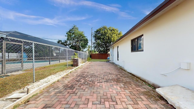 exterior space featuring a lanai, a fenced in pool, and a patio