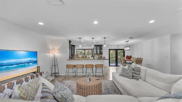 living room with french doors and light hardwood / wood-style floors