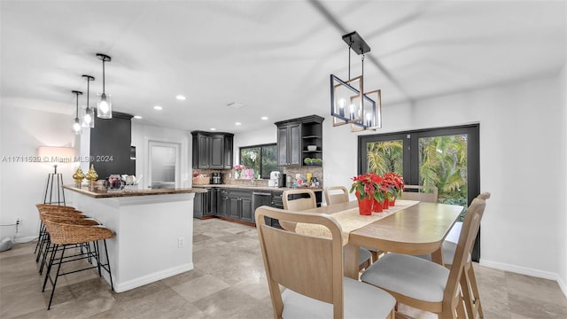 dining area featuring a healthy amount of sunlight and an inviting chandelier