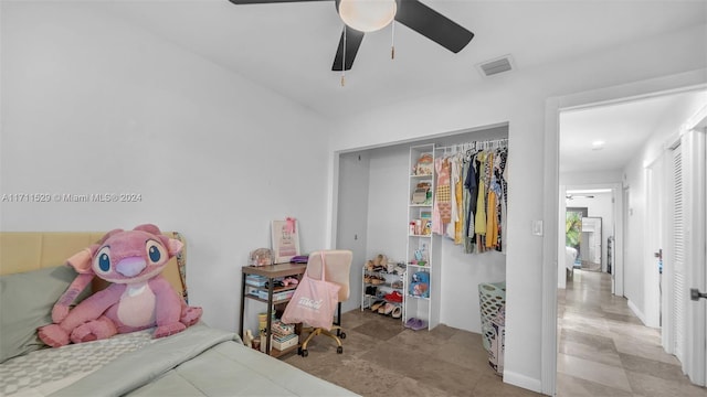 bedroom with ceiling fan and a closet