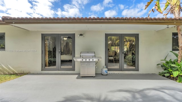 property entrance featuring a patio area and french doors