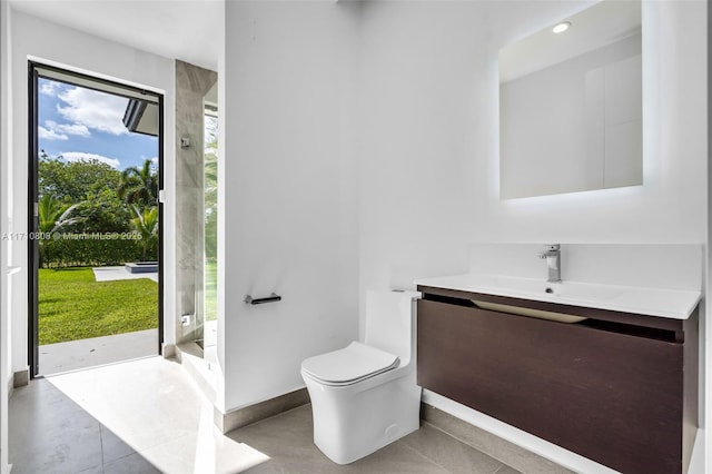 bathroom with vanity, tile patterned flooring, toilet, and a shower